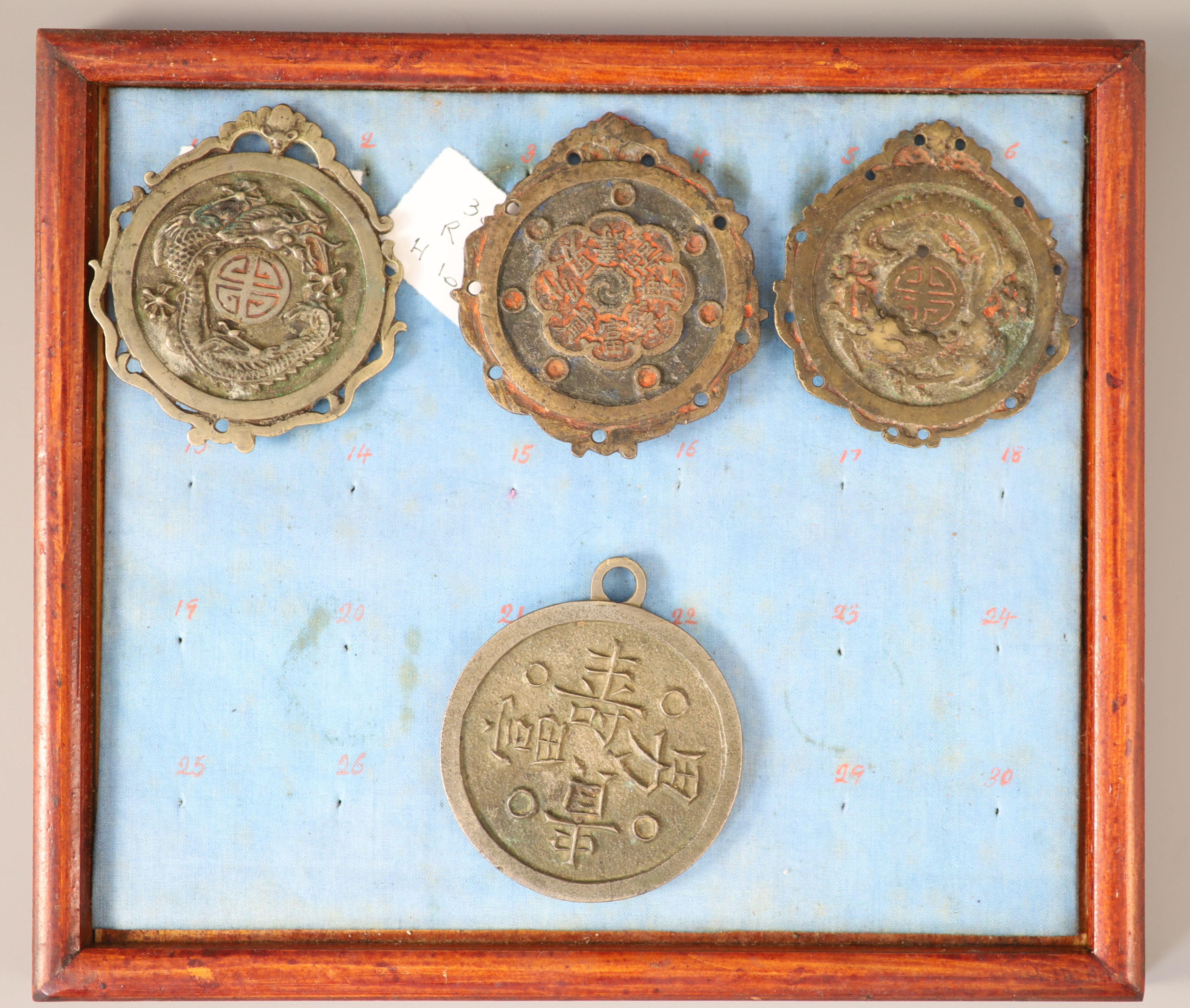 A group of 99 Korean bronze and metal amulets or charms, 19th/20th century